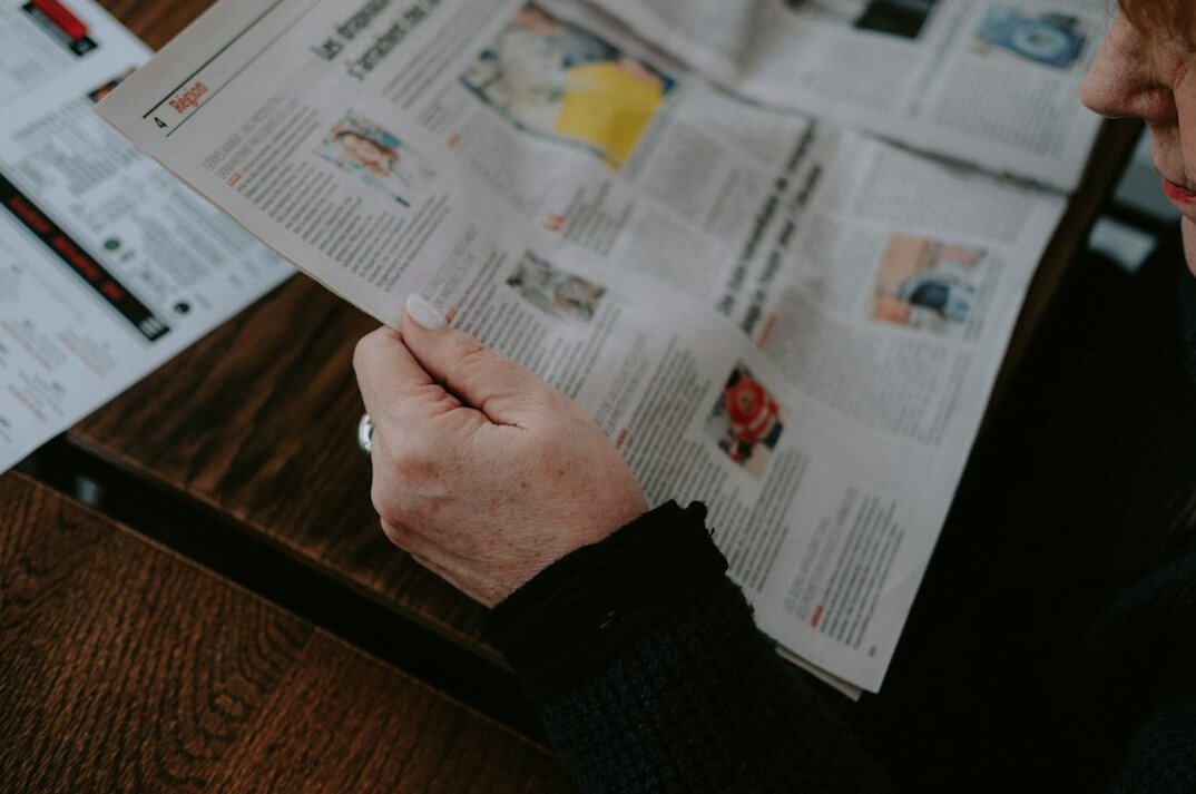person reading newspaper
